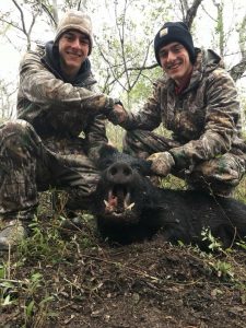 Black boar hunt, presenting fresh kill, brother handshake