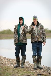 fishing brothers with catch, fresh lake water