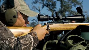 man hunting with rifle | Hooville Ranch hunting and lodging
