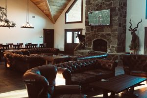 lounge areas in the lodge, football playing on tv | Hooville Ranch hunting and lodging