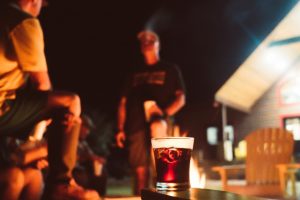 men drinking by the fire | Hooville Ranch hunting and lodging